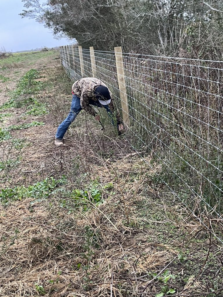 Skilled Fence Installer building a field fence